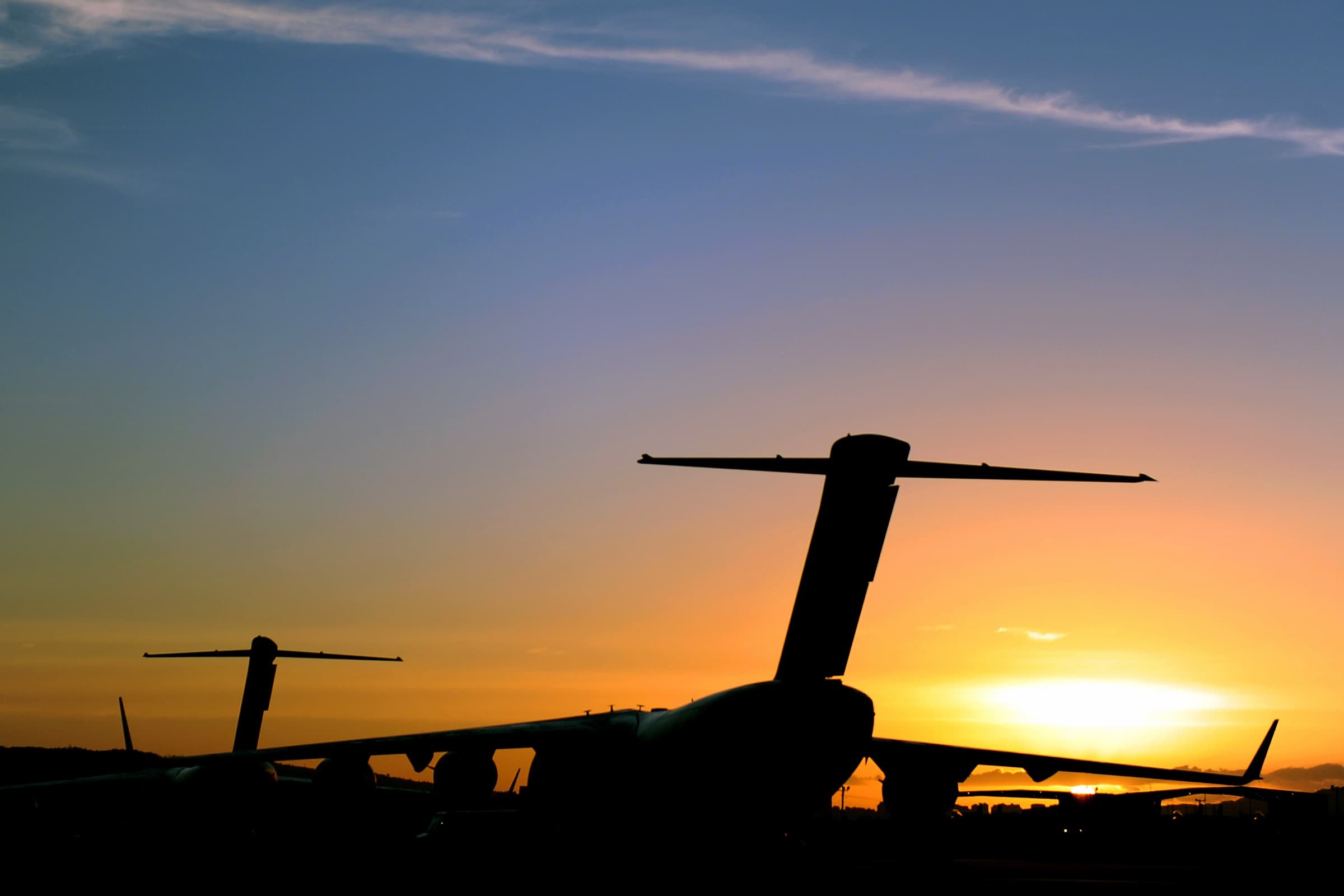 Military transport aircraft on the flight line at sunset