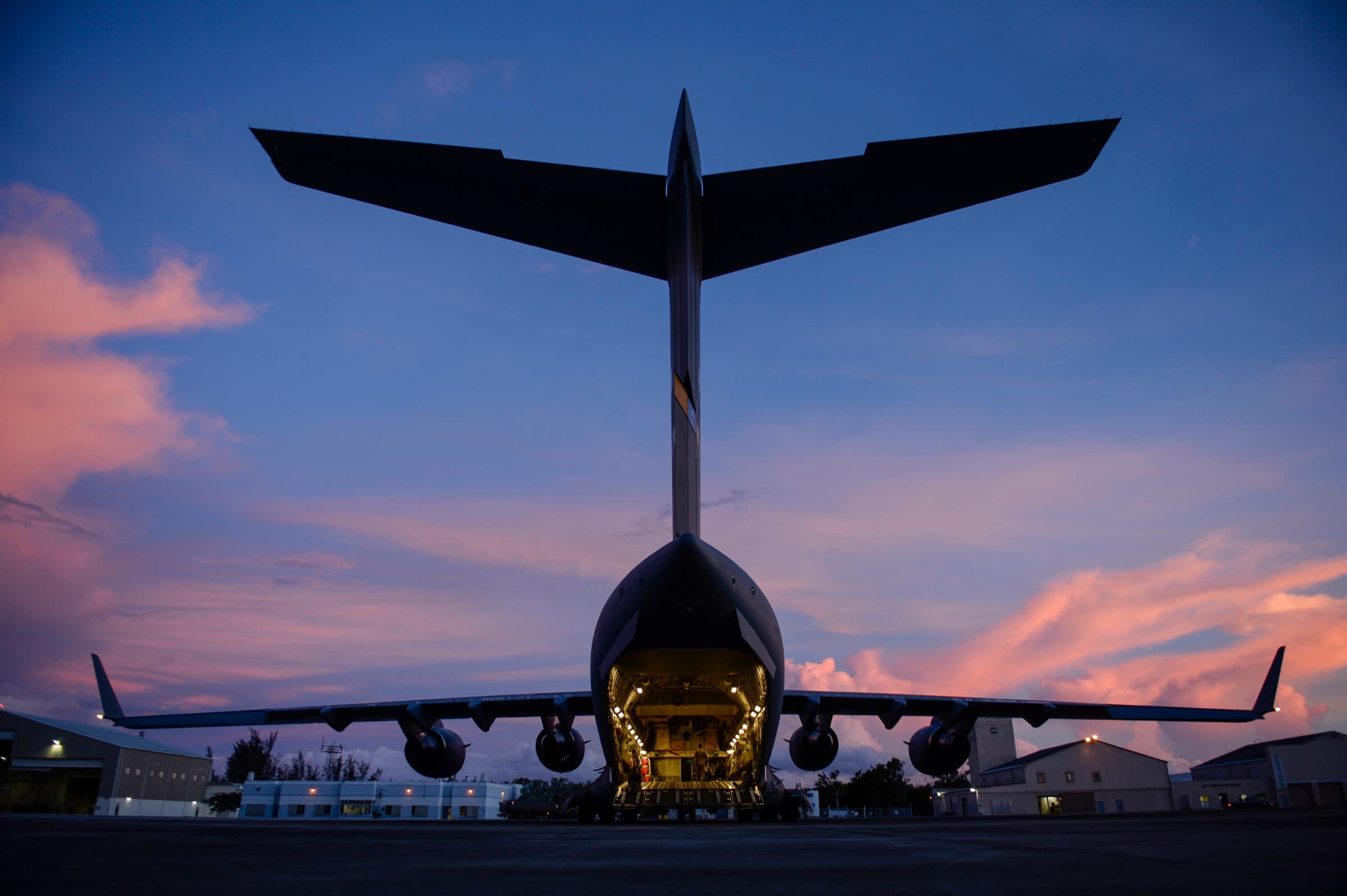A C-17 Globemaster III on the flight line with its cargo ramp open.